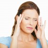 Closeup of a mature woman with a headache against white background